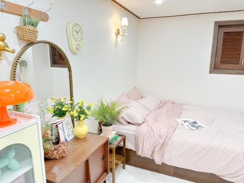 a bedroom with a bed and a desk with a mirror at 8 Hotel in Seoul