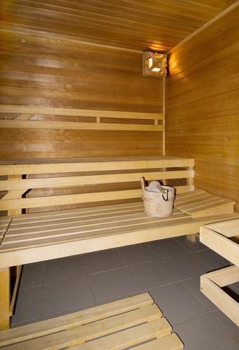 a wooden bench in a sauna with a purse at K-Triumf Resort in Velichovky