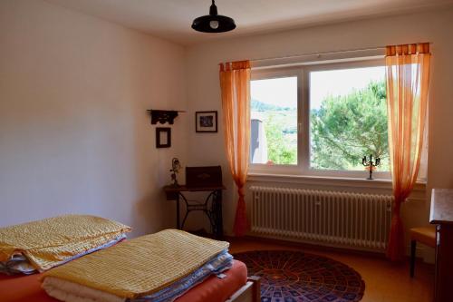 a room with two beds and a window at Ferienwohnung Ruth in Neustadt an der Weinstraße