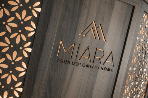 a sign for a m mara your bubbles home at Garni Hotel Miara - Your Dolomites Home in Selva di Val Gardena