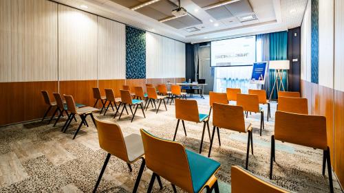 a conference room with chairs and a table in it at Novotel Reims Tinqueux in Reims