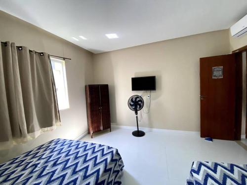 Postel nebo postele na pokoji v ubytování Casa Temporada Jacuípe Guarajuba 3/4 c/ar condicionado
