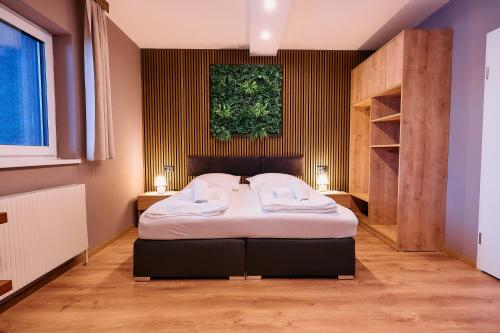 a bedroom with a bed and a painting on the wall at The Art and Sporthotel in Innsbruck