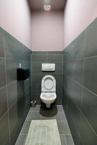 a bathroom with a white toilet in a stall at The Art and Sporthotel in Innsbruck