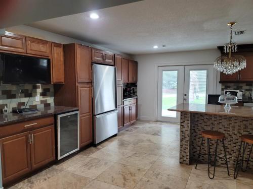 a kitchen with wooden cabinets and a counter top at Desoto Grand Estate Private Luxury Event Retreat in Sarasota