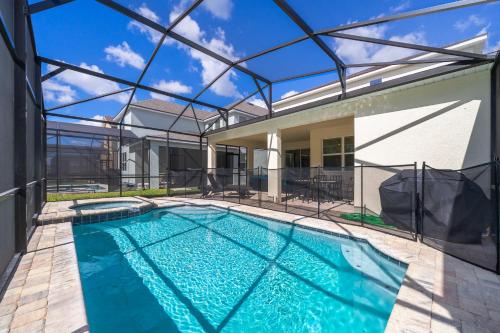 a swimming pool in the backyard of a house at Amazing Villas 20 minutes away from Disney! in Kissimmee