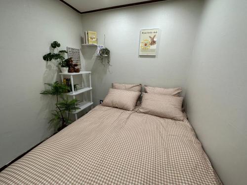 a bed in a room with two pillows on it at 8 Hotel in Seoul
