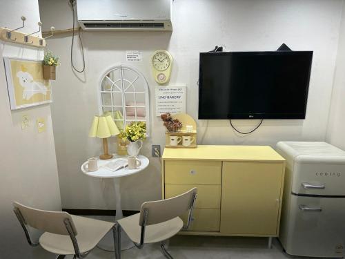 a room with a tv and a table and chairs at 8 Hotel in Seoul