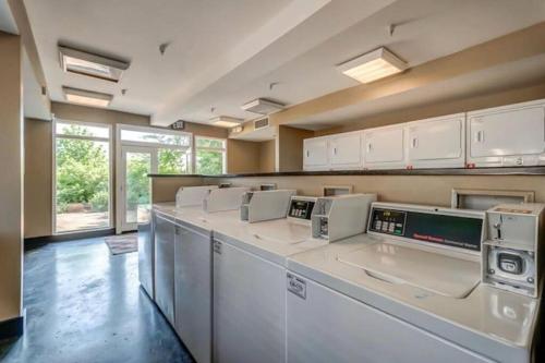 a laundry room with a row of washers and dryers at Condo in the Heart of Nashville - unit794 in Nashville