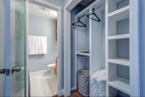 a bathroom with a toilet and a glass door at Condo in the Heart of Nashville - unit794 in Nashville