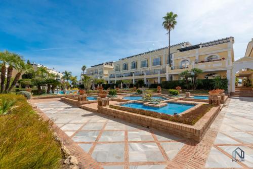 a resort with three pools and a building at Newly Refurbished 2 BDRM Amazing Complex w Pools in Marbella