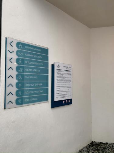 a sign on the wall of a building at Sea Park LeSu 8 The Shore KK I 1 plus 1 Room 2-5 Pax 홈스테이 in Kota Kinabalu
