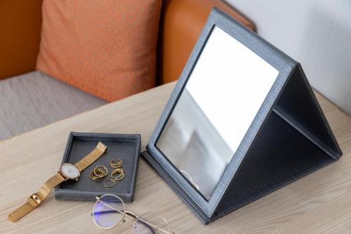 a mirror sitting on a table next to a box of coins at Tokyu Stay Gotanda in Tokyo