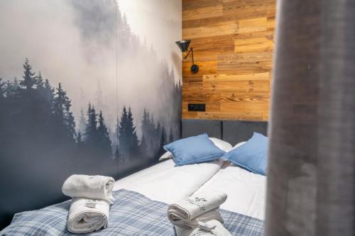 a bedroom with a bed with shoes on it at Canin Mountain Lodge in Sella Nevea