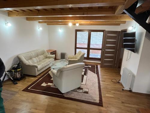 a living room with two couches and a table at Chata u Jána in Zákamenné