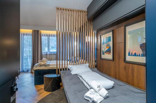 a bedroom with a bed with white pillows on it at Canin Mountain Lodge in Sella Nevea