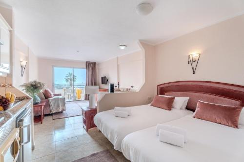 Cet appartement comprend une chambre avec deux lits et un salon. dans l'établissement OBSIDIAN Estudio Santa María, à Adeje