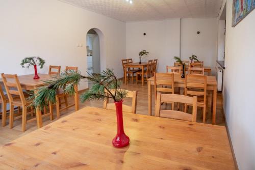 a dining room with a red vase on a table at VacationClub - Ski Lodge Szczyrk Pokój 6 in Szczyrk