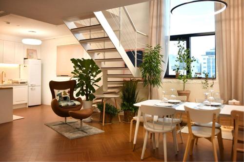 a kitchen and dining room with a table and some plants at Garden Pool Villa Lee Chung Jung in Seoul