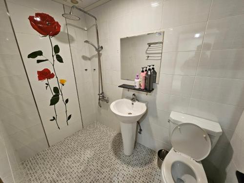 a bathroom with a shower and a toilet and a sink at 8 Hotel in Seoul