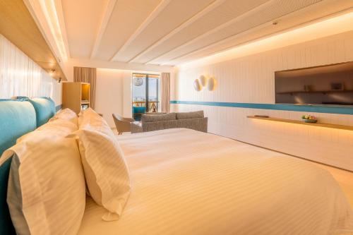 a hotel room with a large bed with pillows at The View Agadir in Agadir