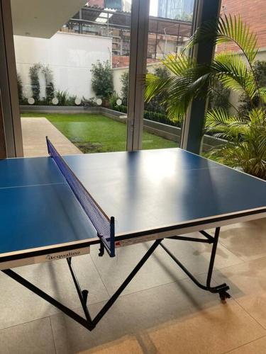 a ping pong table sitting in a room at Gold & Black, Premiere Suite and Pool, Sector Carolina in Quito