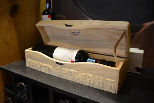 a bottle of wine in a wooden wine box at Hotel Nar in Trebinje