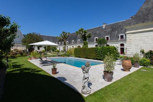 une maison avec une piscine dans une cour dans l'établissement Le Clos Chavigny, à Lerné