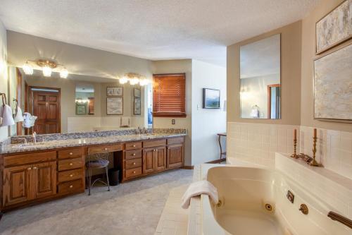 a large bathroom with a tub and a sink at Misty Lake Hot Tub w Lake Access in Oak Ridge