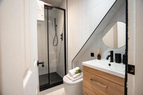 a bathroom with a shower and a toilet and a sink at The West End Retreat - Your Luxurious 5* Apartment in Glasgow