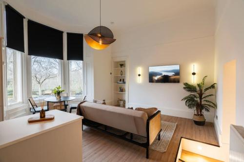 a living room with a couch and a table at The West End Retreat - Your Luxurious 5* Apartment in Glasgow