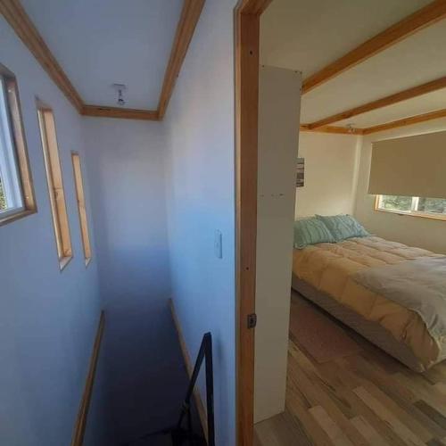a bedroom with a bed in a room with a window at Loft a pasos de la playa in La Serena