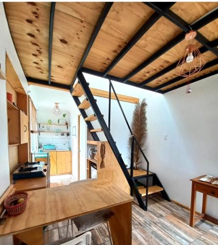 a loft conversion with a staircase in a room at Loft a pasos de la playa in La Serena