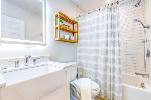 a white bathroom with a sink and a toilet at Great Marsh House in Essex