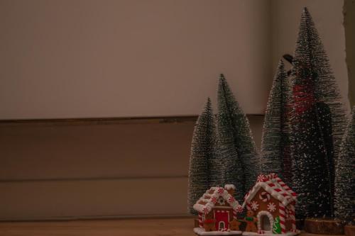 a group of christmas trees with a gingerbread house at La Casetta. Feel at home. in Castelfidardo
