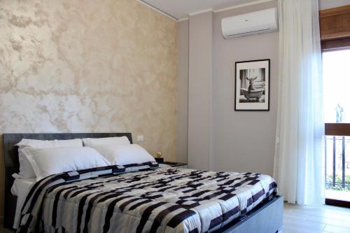 a bedroom with a bed with a blanket on it at C’era Una Volta Affittacamere in Colle di Tora