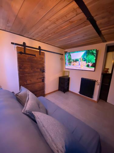 a bedroom with a large bed and a projection screen at Chambre privée in Aime-La Plagne