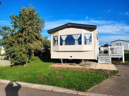 a tiny house sitting on the side of a street at LuaMar Holidays- Tattershall Lakes - Lancaster Crescent in Tattershall