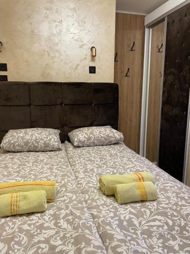 a bed with two pillows on top of it at Loronobeo.forest in Belgrade