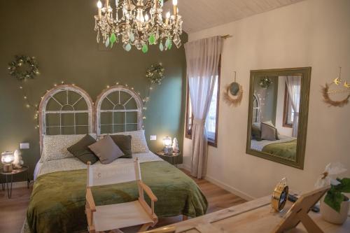 Un dormitorio con una cama grande y una lámpara de araña. en La Casetta. Feel at home., en Castelfidardo