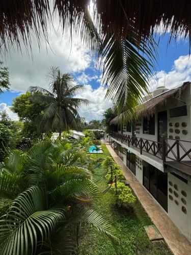 a view of the courtyard of a resort with palm trees at Casa Delia Hotel Downtown in Bacalar