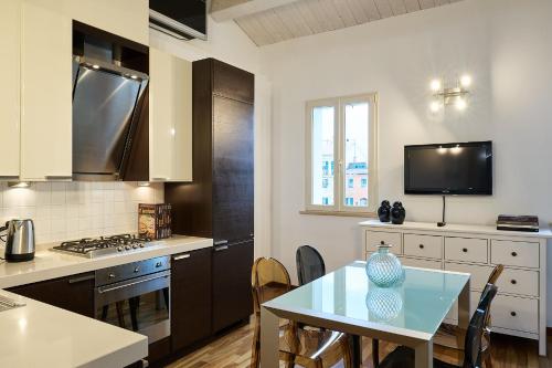 a kitchen with a table and a counter top at Loft del Faro in Fano
