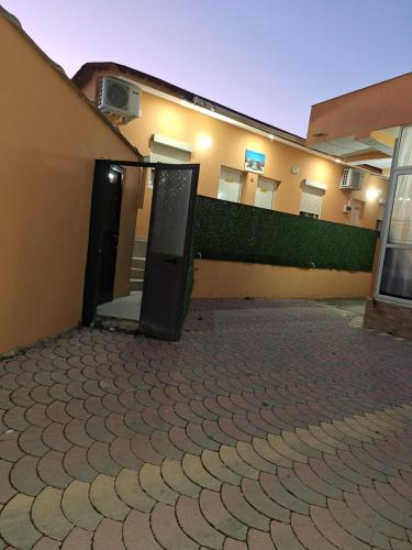 a building with two doors on the side of it at Hotel Sabi in Veminasi