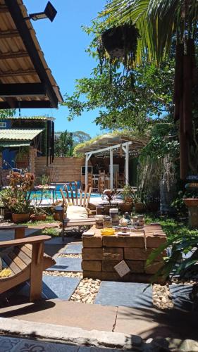 un patio con tavolo, sedie e piscina di Pousada ZAUA GUEST HOUSE a Florianópolis