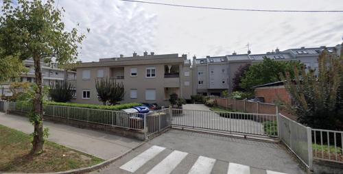 a building with a fence in front of a street at Apartman Gajeva in Samobor
