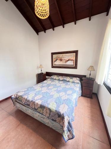 a bedroom with a bed and a chandelier at Complejo Aires 1 in San Bernardo