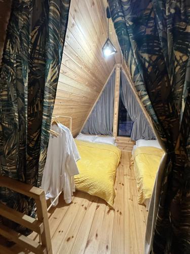 a room with two beds in a tent at Borjomi Story in Borjomi