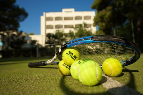a group of tennis balls and a racket on a court at Hotel Portonuovo in Vieste