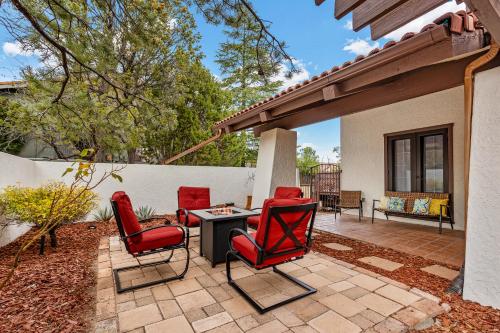 a patio with red chairs and a table at Large Spanish Villa -Hot tub- Pool -Gym- Game Room in Sedona