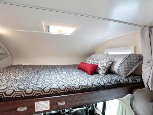 a small bed in the back of an rv at Zebra motorhome hire in Ravensworth